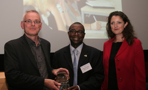 Victoria Hills presenting the award to Colin Brader and Dr Antony Mobereola
