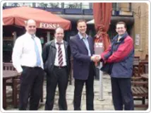 TPS Board member Jamie Wheway presents the trophy to members of the Notts County Council team.